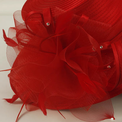 Close-up of red church hat fabric texture and decorative netting with rhinestone details, highlighting high-quality craftsmanship for formal women’s hat