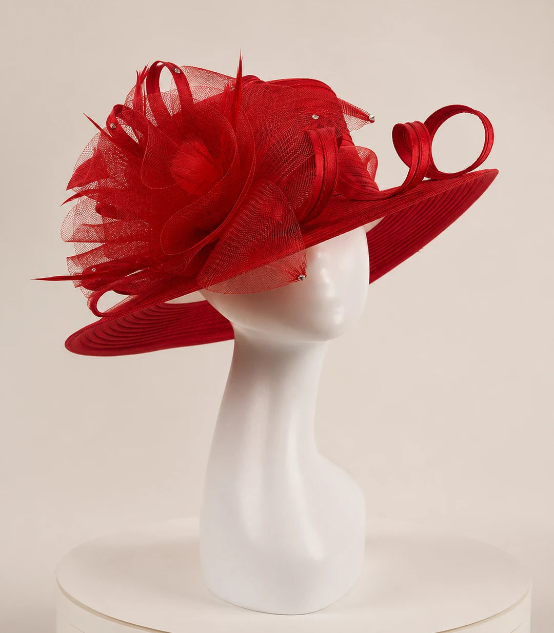 Side view of red church hat on mannequin, showing intricate netting, satin ribbon loops and rhinestone details, formal women’s hat for high-end occasions