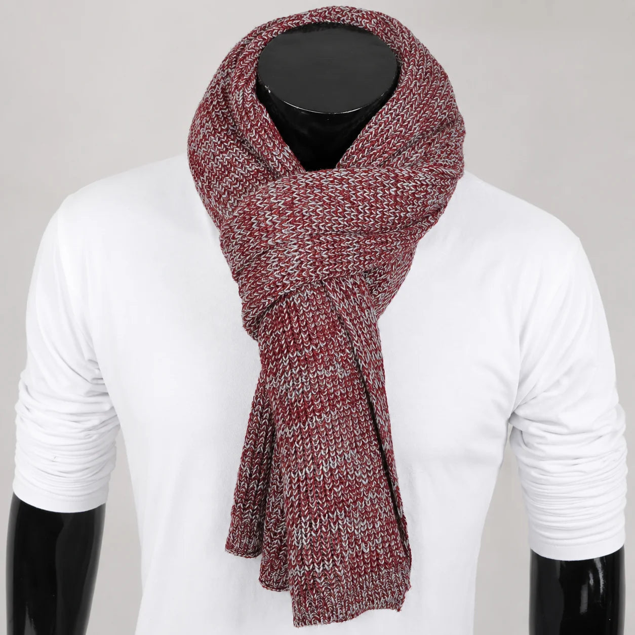 Red melange knit scarf styled on mannequin, warm ribbed texture for winter fashion layering