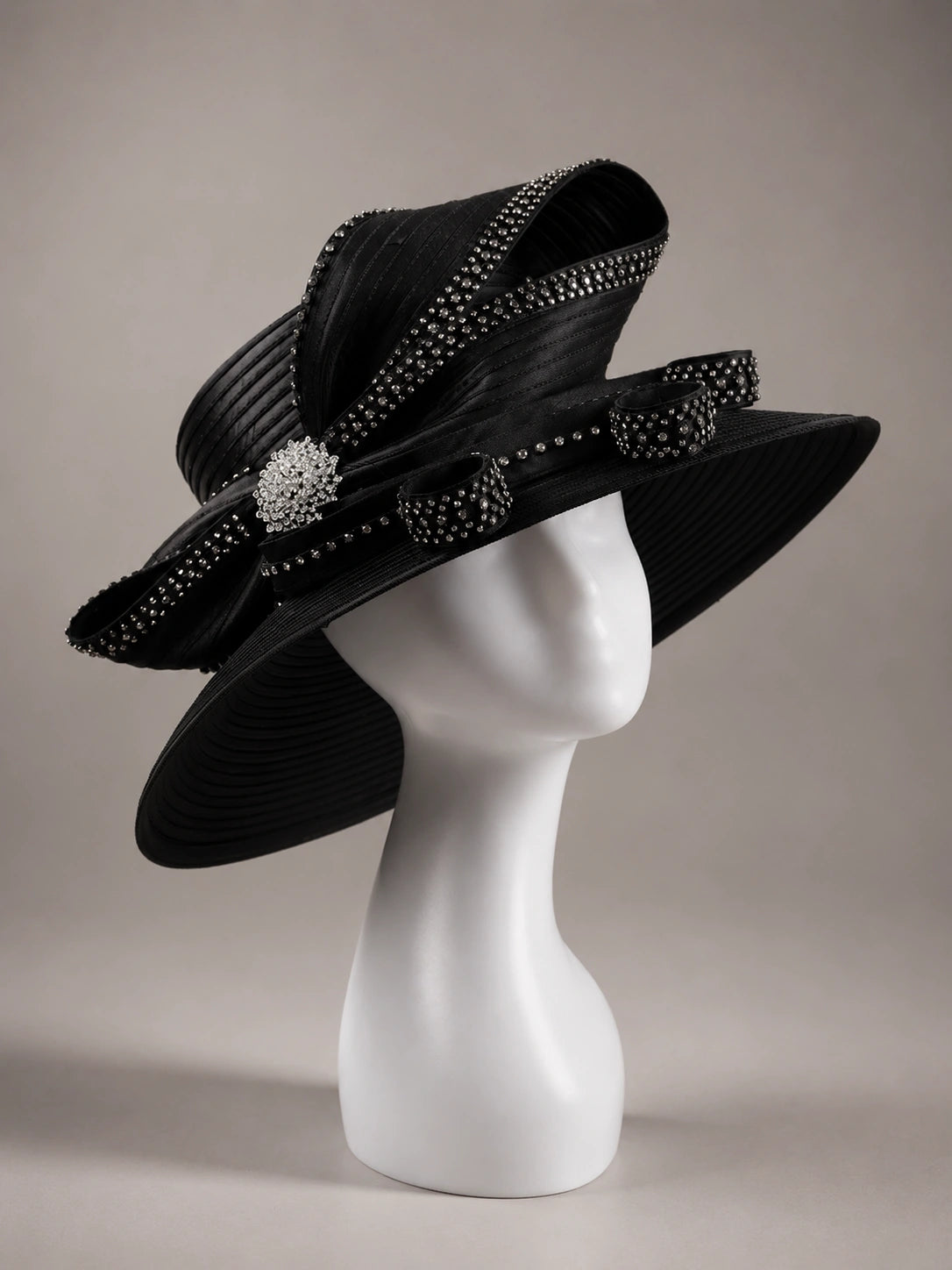 Black rhinestone church hat on mannequin with elegant wide brim and luxury ribbon detailing for formal occasions