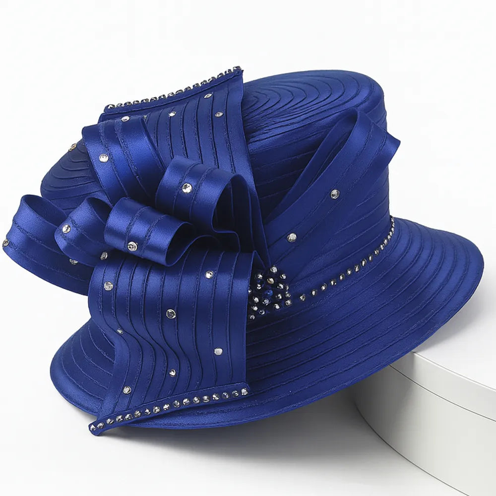 Elegant royal blue church hat with rhinestone bow detail on white turntable, perfect for women’s Sunday service or formal events