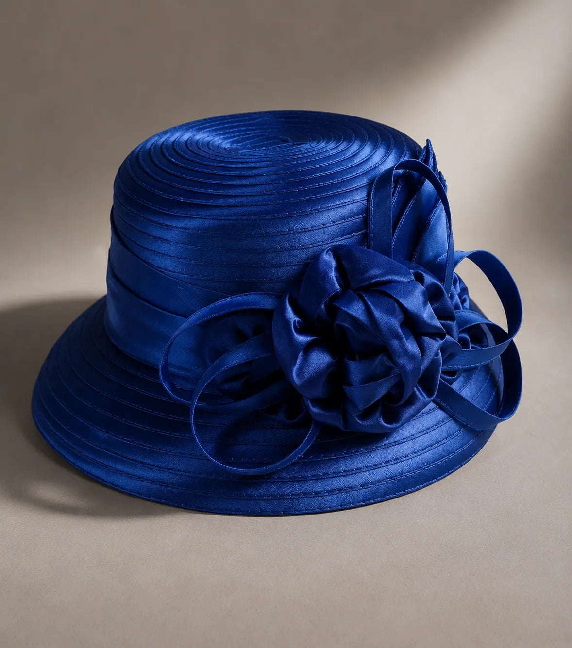 Flat lay of royal blue cloche short brim church hat with ribbon flower, stylish women’s hat for formal occasions, FORBUSITE premium hat