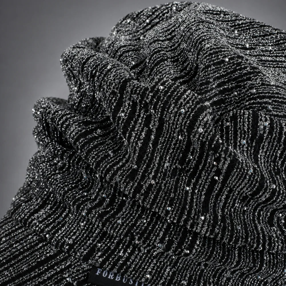 Close-up of textured ruched visor cap fabric with glued rhinestone decoration