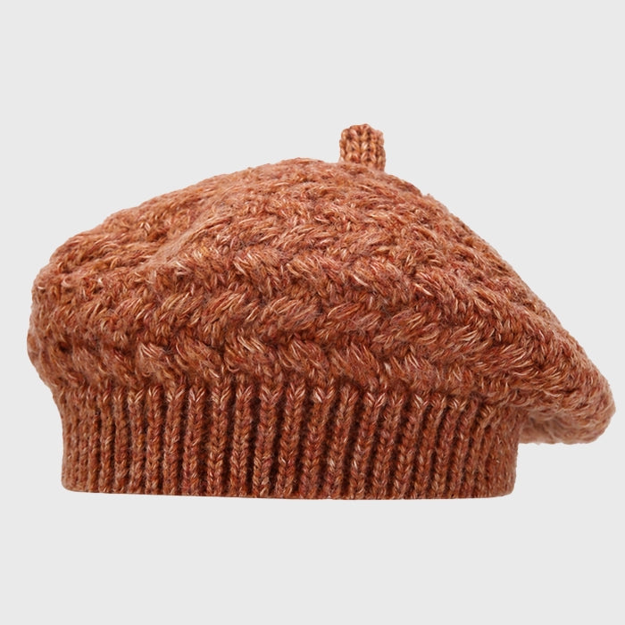 Rust crochet cable knit beret for women, adding a touch of autumn warmth and style. Adjustable fit for comfort and perfect for winter fashion.