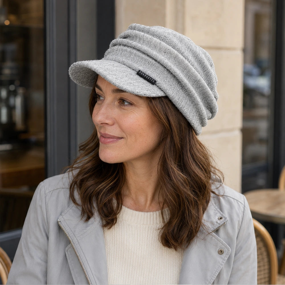 Woman wearing a silver gray ruched visor cap for casual everyday styling