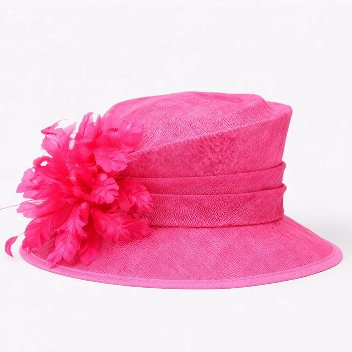 Vibrant hot pink sinamay hat with a stunning feather flower accent, perfect for a formal church event or tea party.