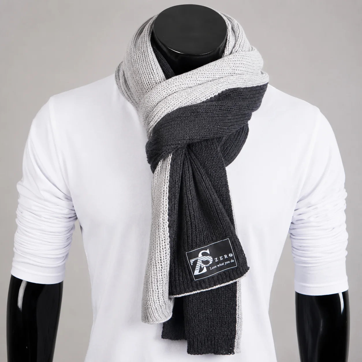Soft grey ribbed knit scarf on mannequin, minimalist winter fashion accessory with clean texture and neutral tone
