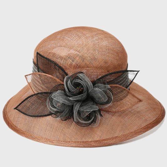 Stylish tan cloche sinamay hat with a black flower accent, perfect for weddings, formal events, and outdoor gatherings.