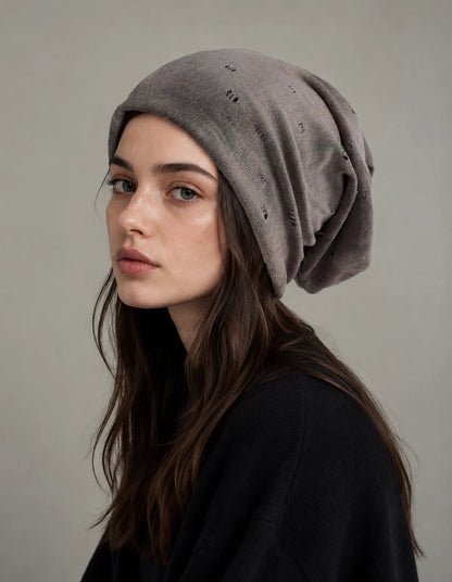 Taupe grey slouchy beanie hat for women with soft distressed fabric, loose oversized fit and minimalist casual outfit styling