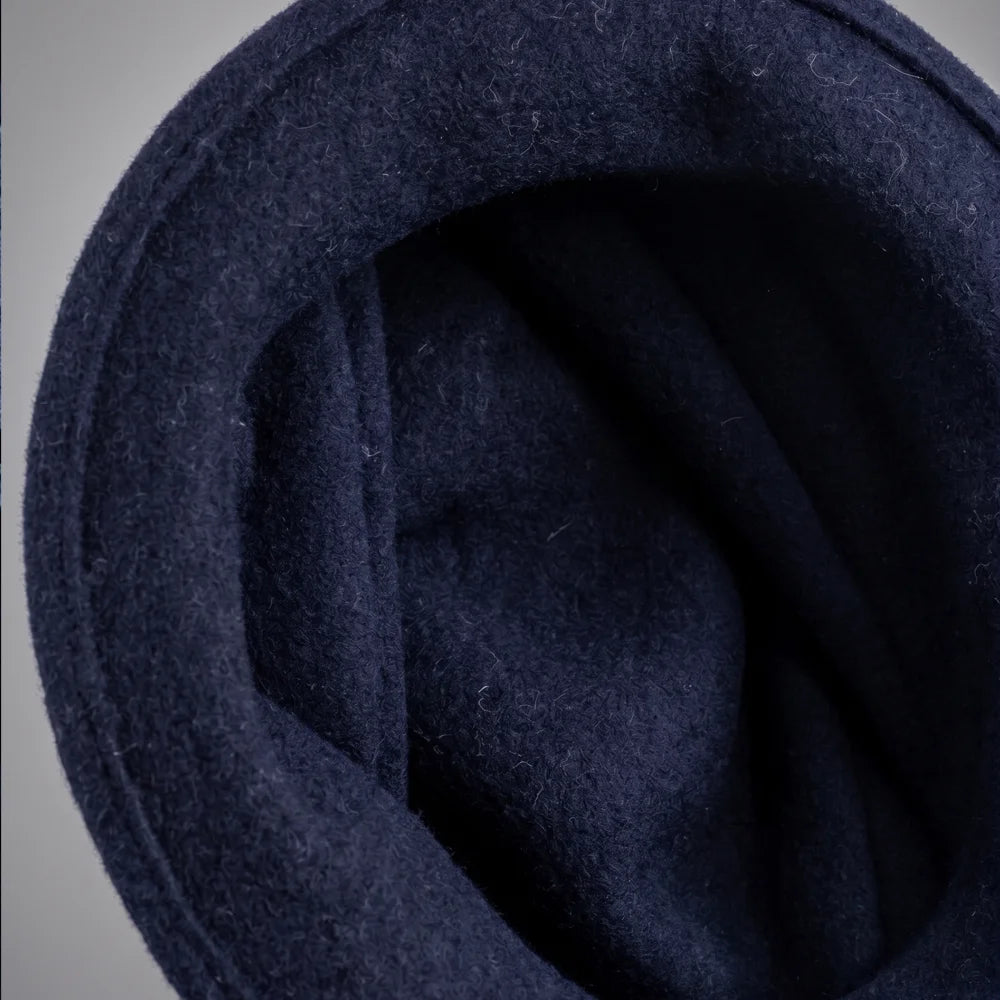 Interior view of an unlined navy boiled wool felt cloche hat
