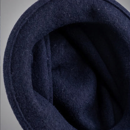 Interior view of an unlined navy boiled wool felt cloche hat