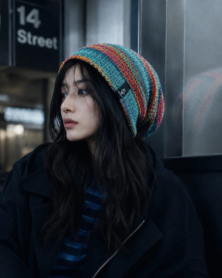 Woman wearing colorful slouchy beanie in urban street style fashion setting