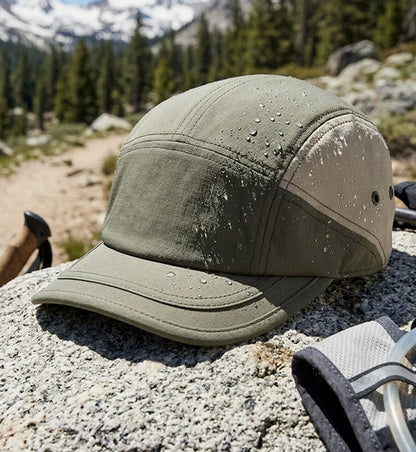 Water-resistant outdoor cap with short brim, designed for lightweight comfort and UV protection during sports