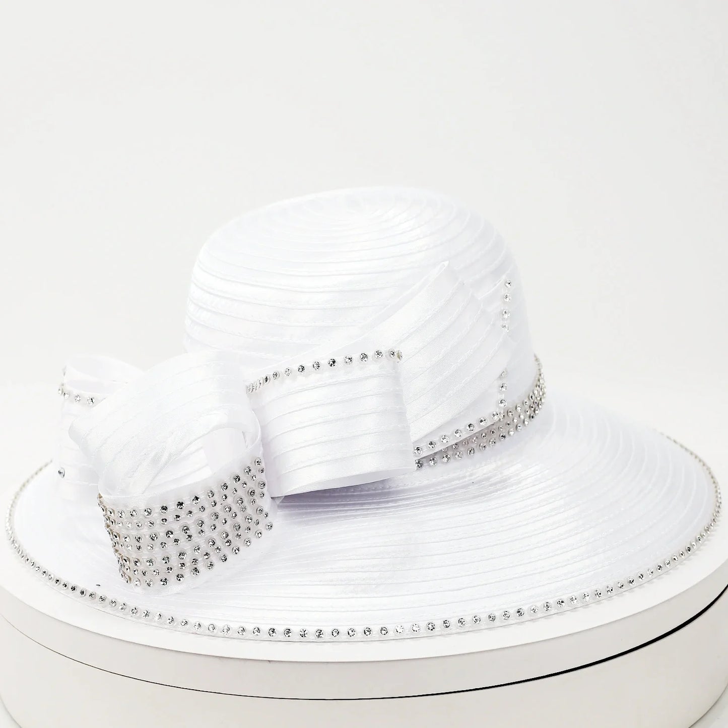 White wide-brim church hat with pleated satin texture and rhinestone ribbon bow, ideal for weddings and Sunday service