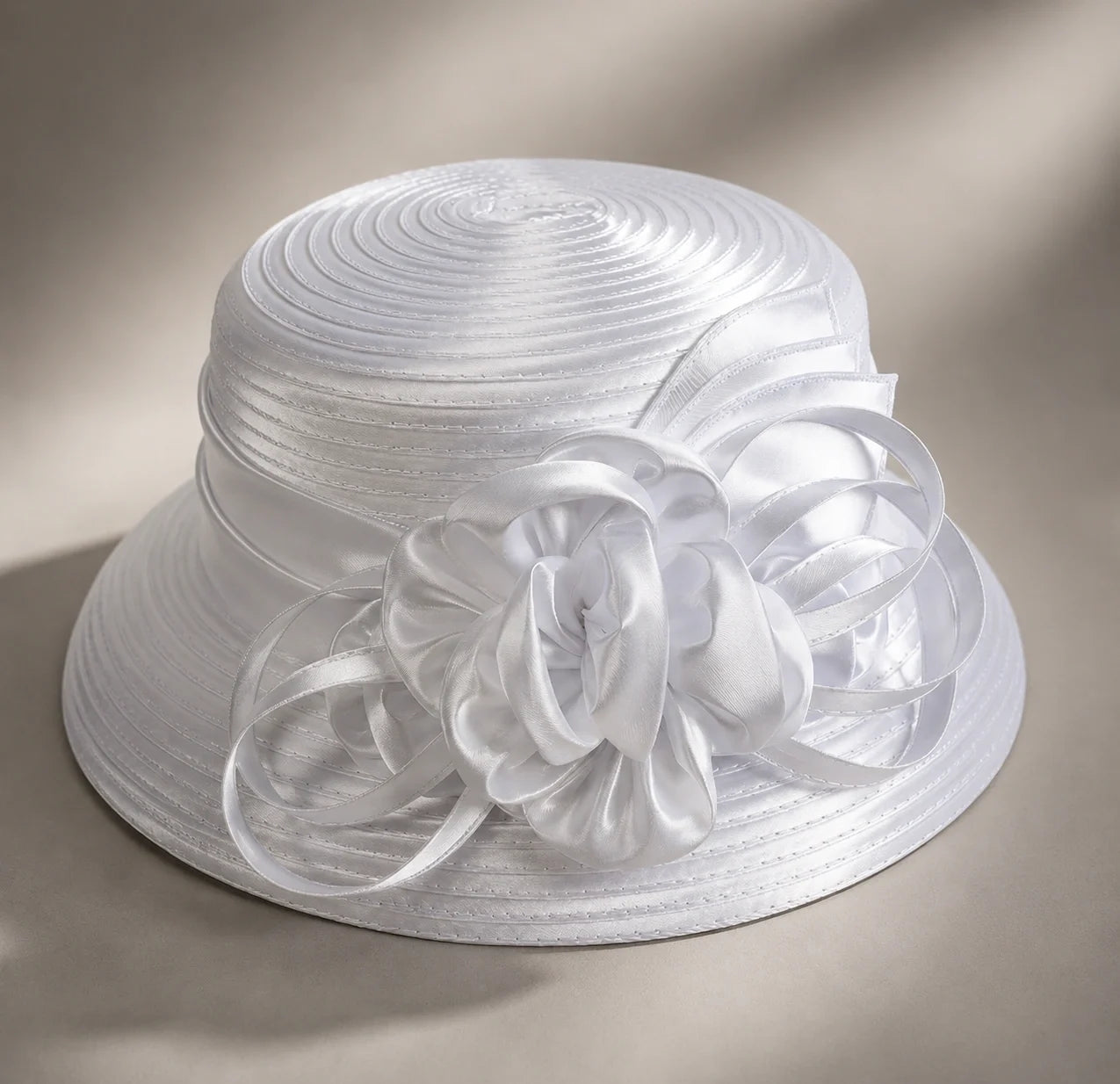 Flat lay of white cloche short brim church hat with satin ribbon flower, elegant Sunday and wedding hat, FORBUSITE premium hat