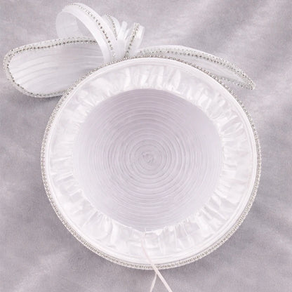 Close-up of a white satin church hat with crystal embellishments, designed for weddings and formal events.