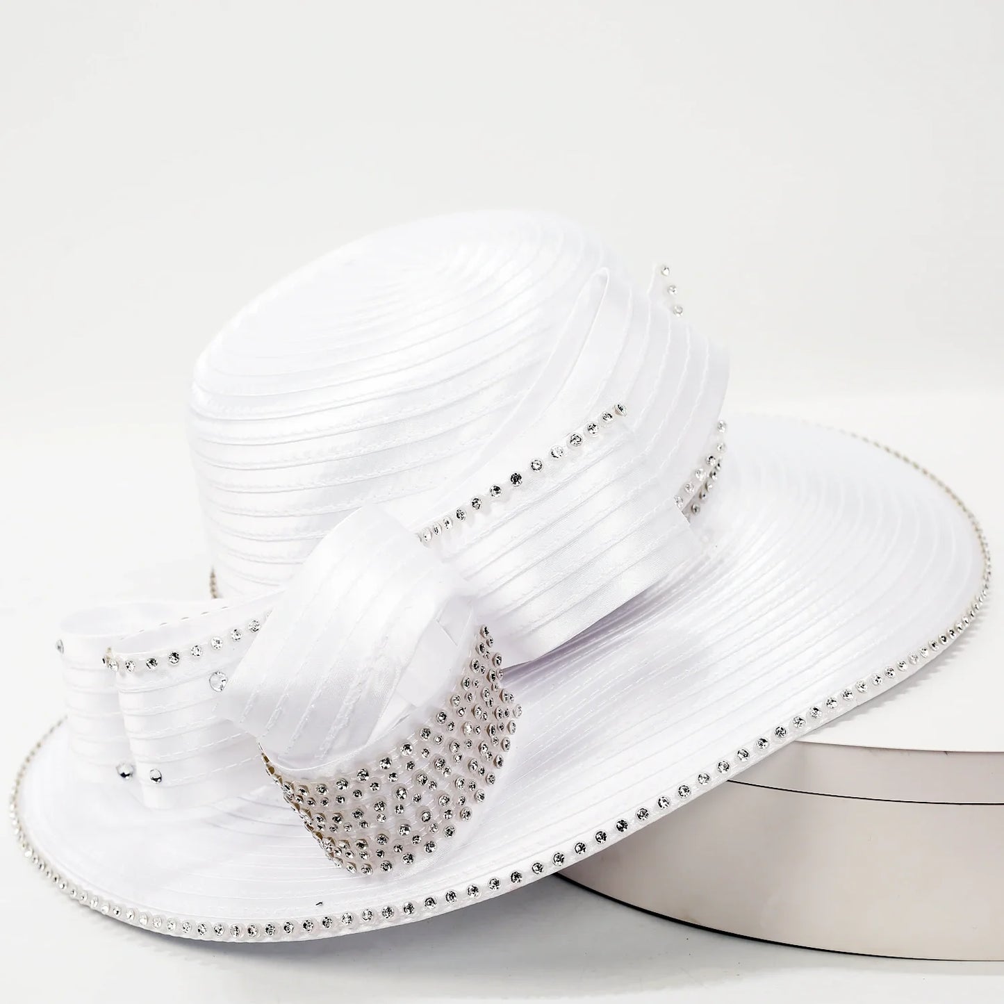 White wide-brim church hat with pleated satin texture and rhinestone ribbon bow, ideal for weddings, tea party and Sunday service