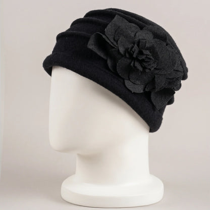 Black brimless boiled wool cloche hat with ruched crown and floral decoration