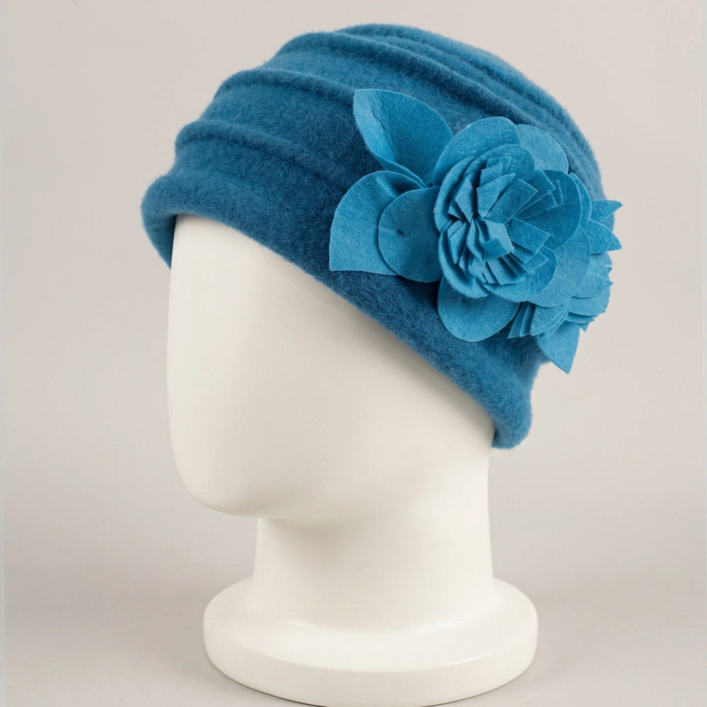 Bright blue brimless boiled wool cloche hat with fixed contrasting flower