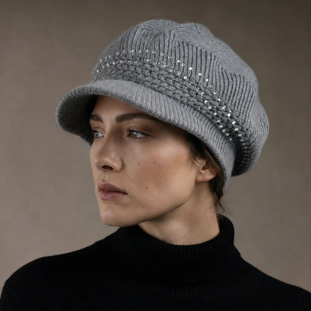 Woman wearing a gray knit visor beanie with sequin detail in a studio