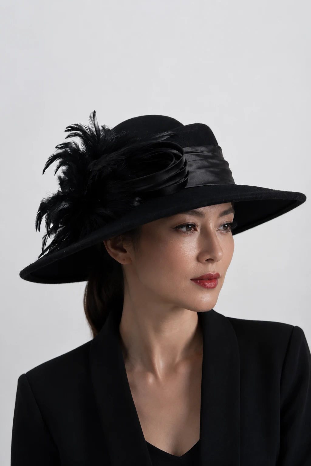 Black wool church hat with wide brim, satin band and feather accent, luxury women’s formal hat for church, funeral, wedding and dressy occasions.