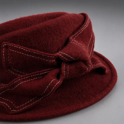 Close-up of wool felt texture and contrast stitching on the side bow