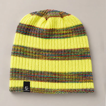 Yellow slouchy knit beanie with colorful rainbow stripe pattern and soft winter texture